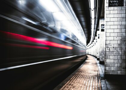 time lapse photography of train in tunnel