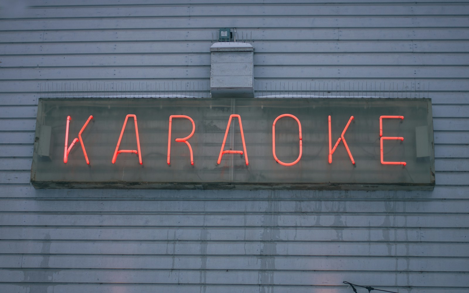 a neon sign on the side of a building