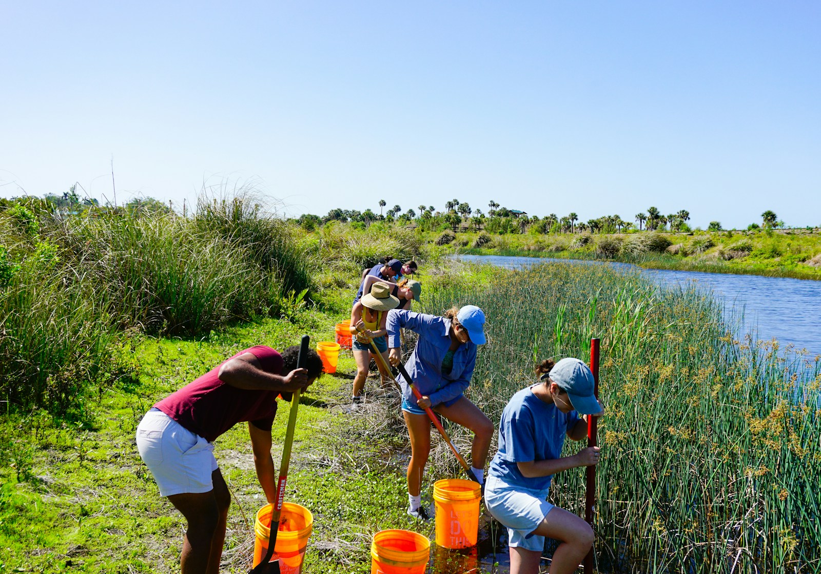 a group of people standing next to a river