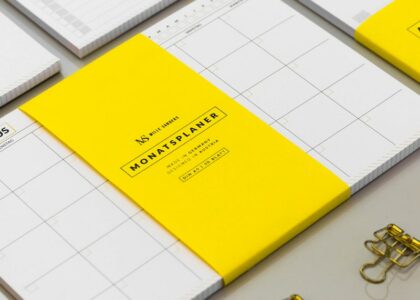 a group of yellow and white binders sitting on top of a table