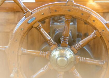 A close up of a steering wheel on a boat